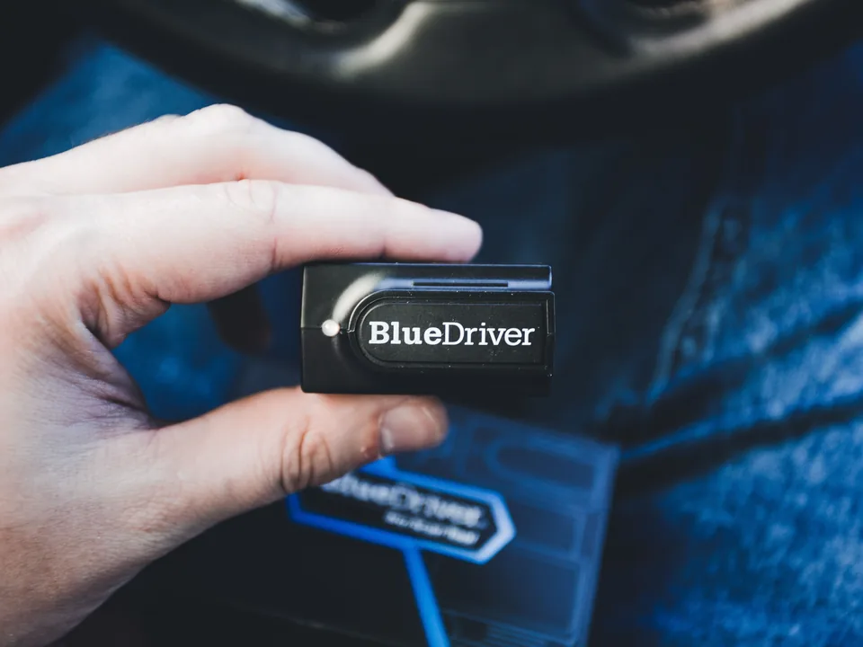 BlueDriver OBD2 scanner held inside a vehicle