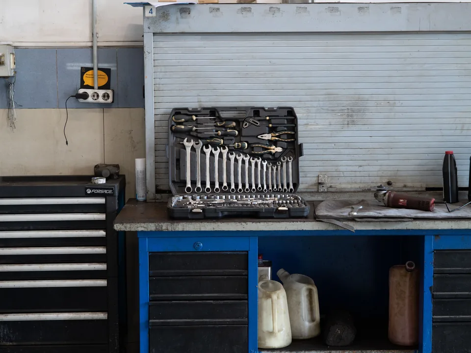 Real mechanic tools organized on a garage workbench